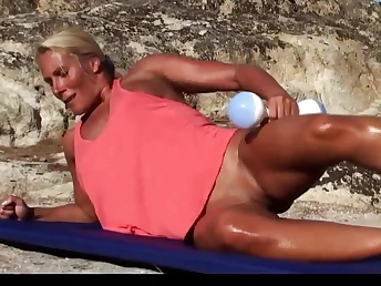 Blonde milf working out unmask on an obstacle beach looking amazingly hot